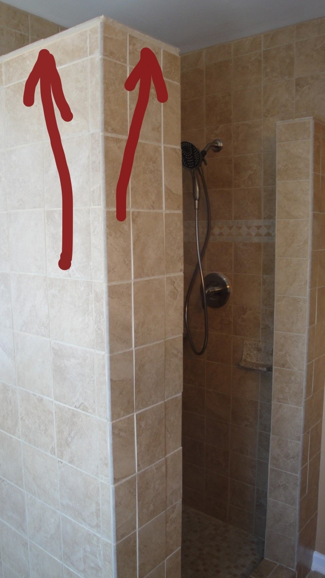 Notice the excessive grout joint that this tile "placer" at the top of the shower wall