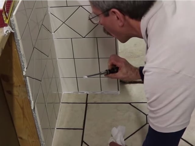 Scott checks for thinset or grout that may have been allowed to remain behind the sealant joint. 