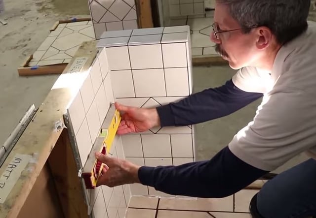 Scott checks the installation for both level and plumb on all three walls. 