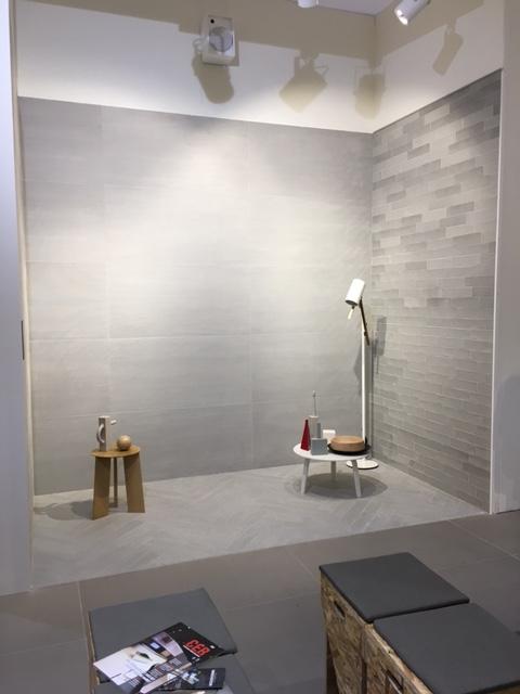Here's a wall with considerable shade variation. It contrasts beautifully with the low-contrast large format wall tile, and the wood plank chevron floor pattern.