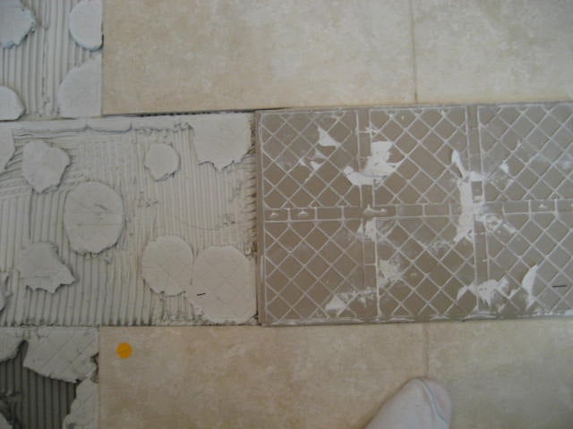 Spot bonding creates bare spots or voids under the tile