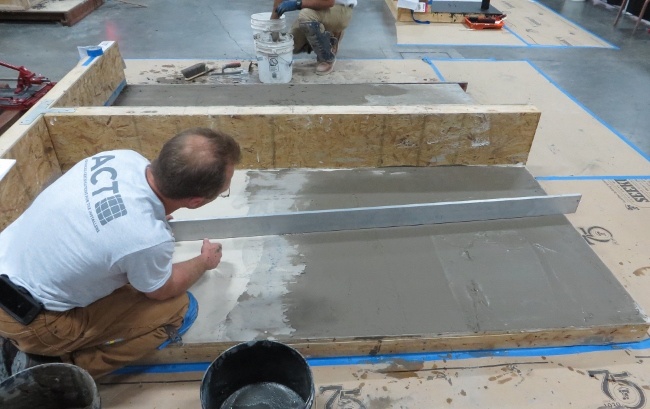 Use a long straightedge to determine if the trowel applied patch is flat enough for large format tile.