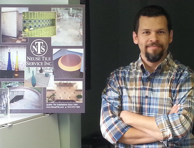Neuse Tile Service's Juan Sauceda CTI#64, with a poster depicting many projects that he has either overseen or installed.