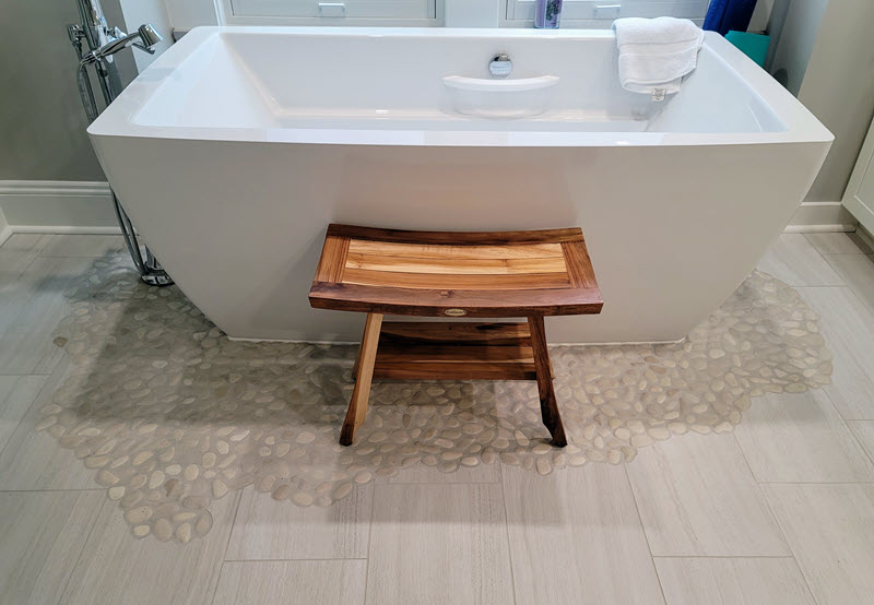 Finished soaker tub with pebble floor surround