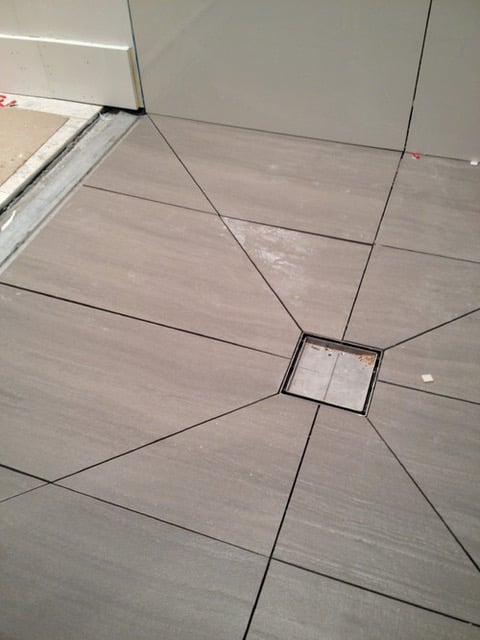 Notice that all directions of these shower floors must slope to the drain.