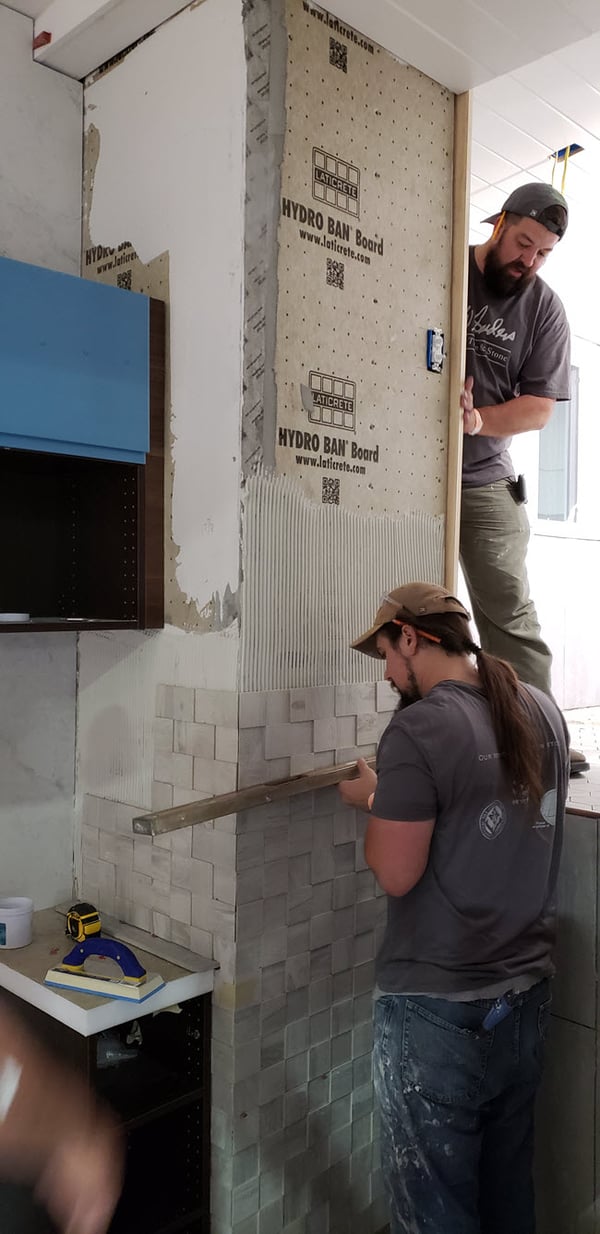 DW Sanders installing tile in a tiny home at Coverings 18